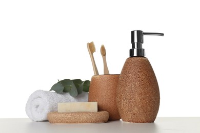 Photo of Bath accessories. Different personal care products and eucalyptus branch on table against white background