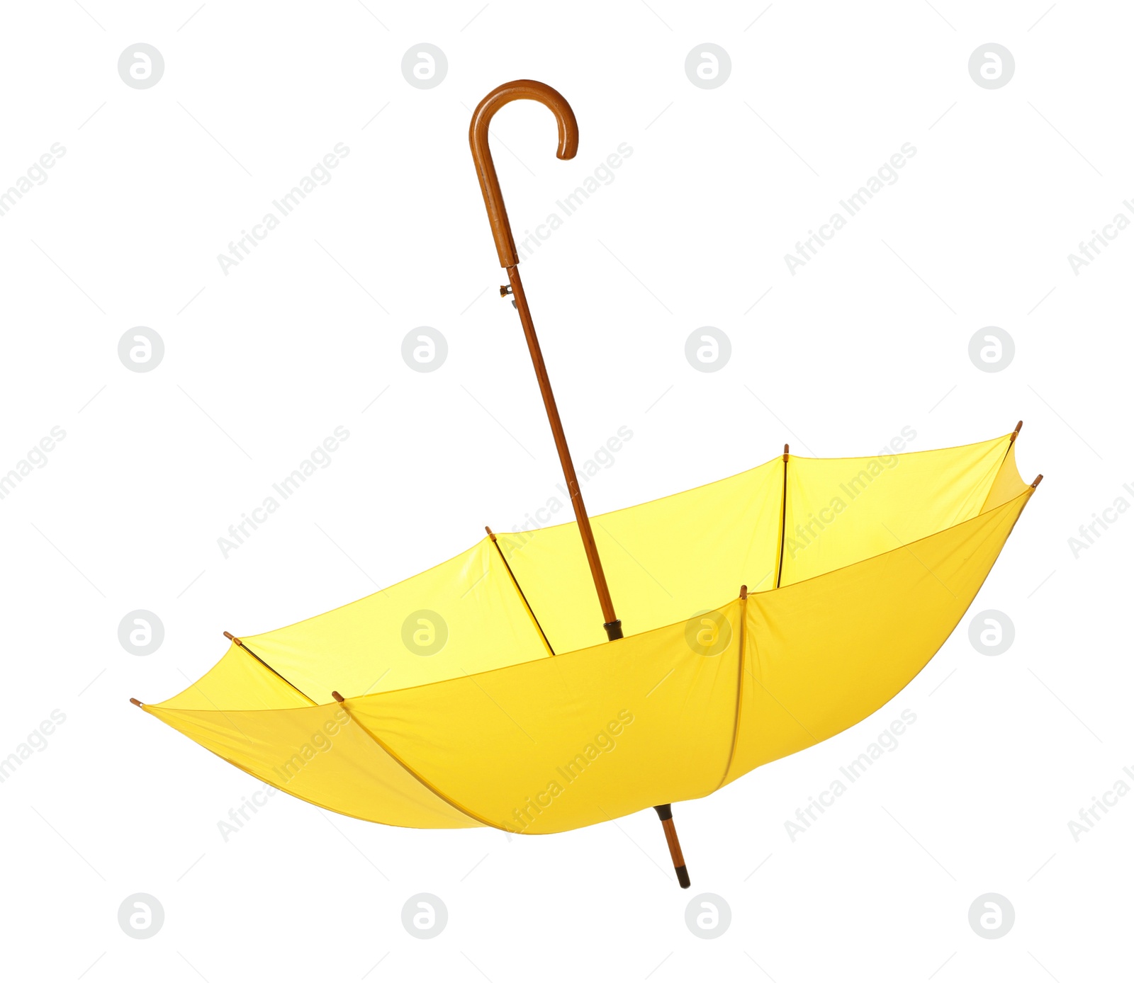 Photo of Modern opened yellow umbrella isolated on white