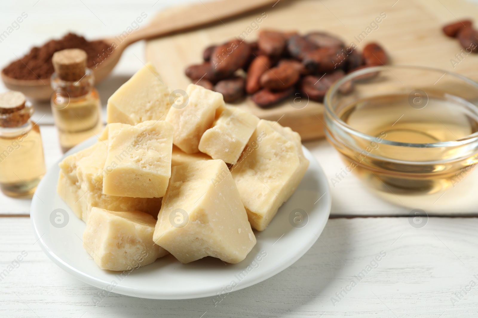 Photo of Organic cocoa butter on white wooden table