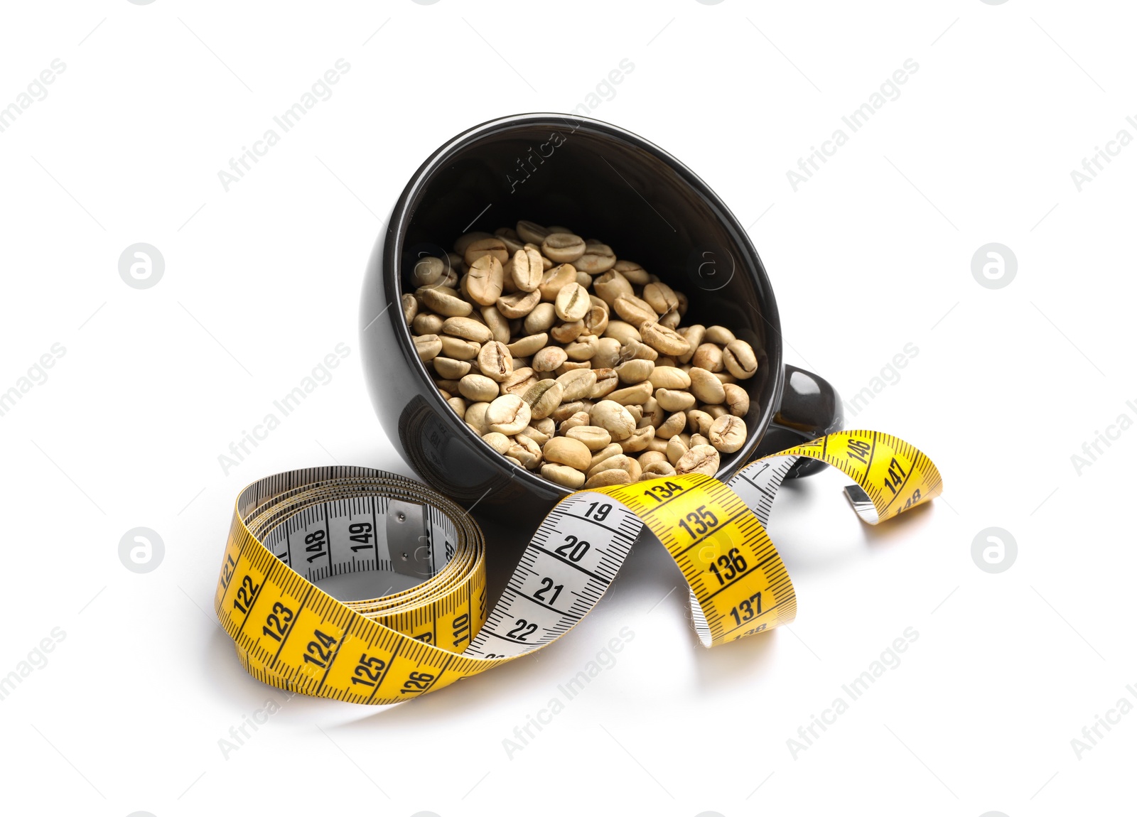 Photo of Cup with green coffee beans and measuring tape on white background