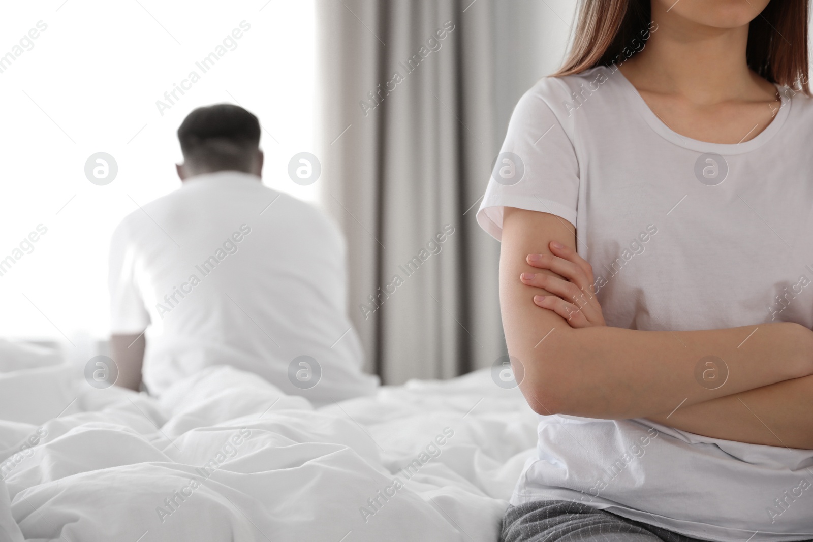 Image of Unhappy young couple with relationship problems at home, closeup. Cheating and breakup