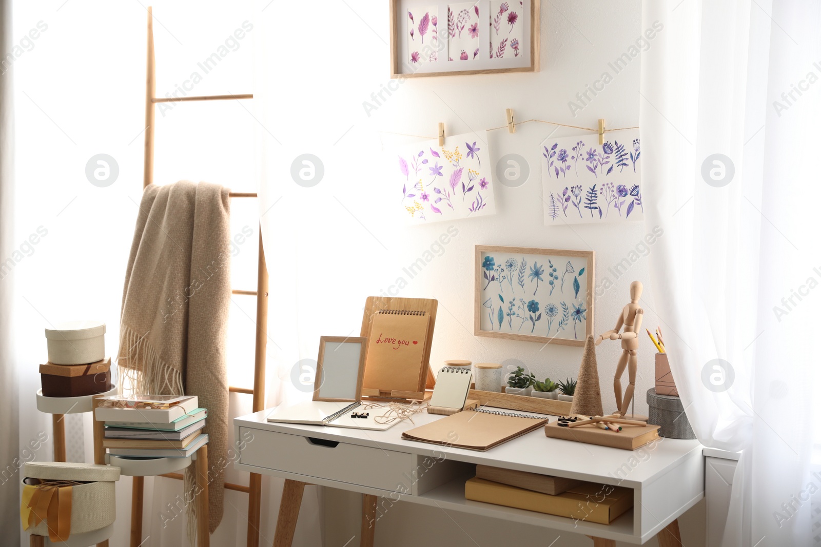 Photo of Stylish room interior with creative workplace near white wall