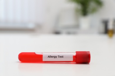 Photo of Tube with label ALLERGY TEST on white table, space for text