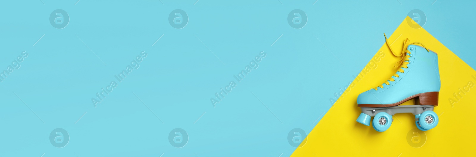 Image of Stylish quad roller skate on color background, top view with space for text. Banner design
