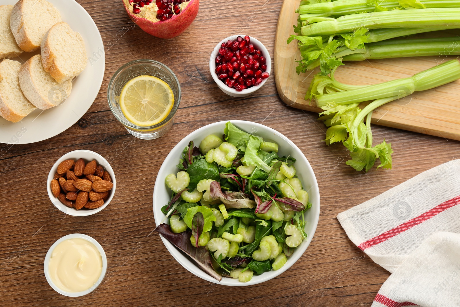 Photo of Delicious fresh celery salad served on wooden table, flat lay