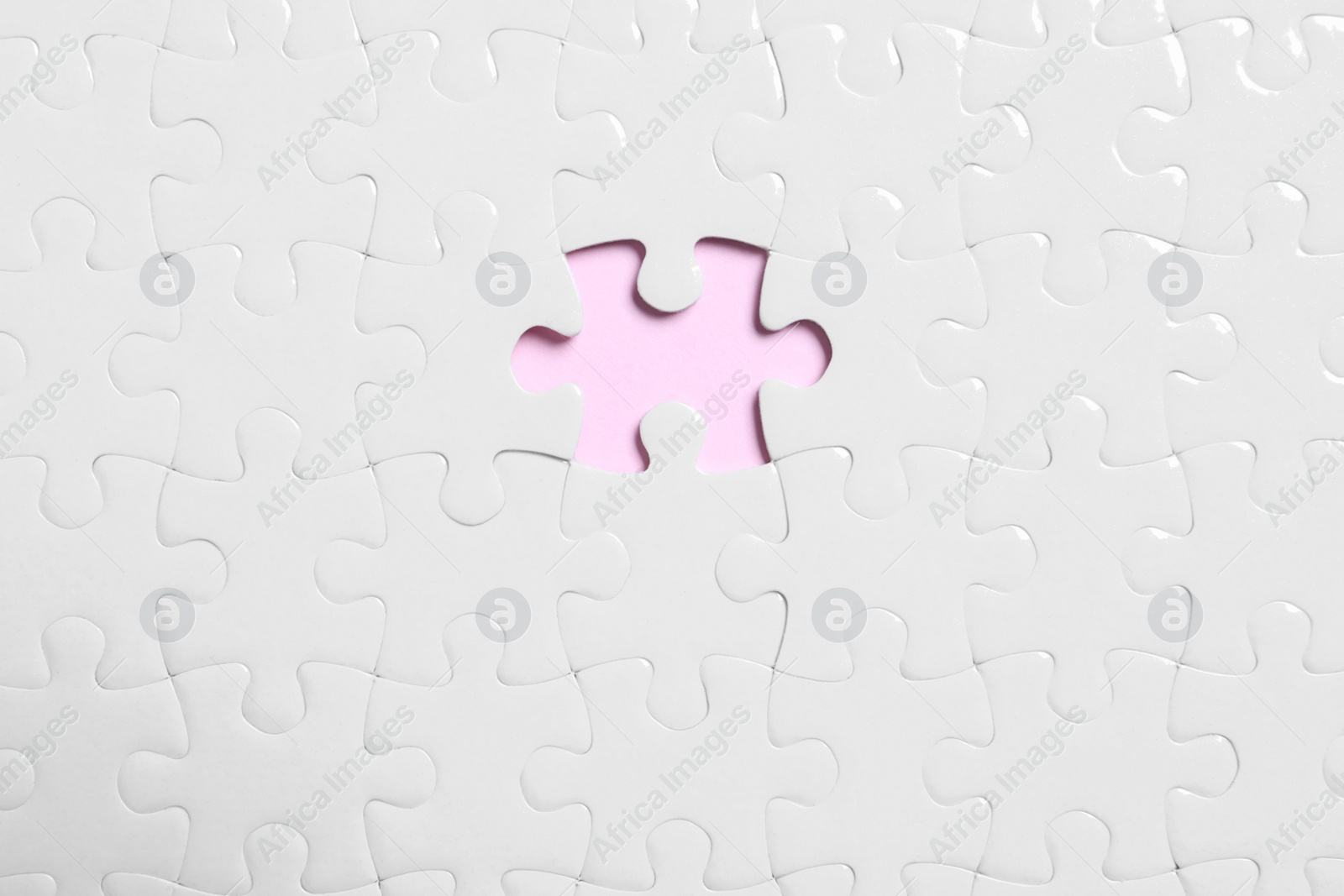 Photo of Blank white puzzle with missing piece on pink background, top view