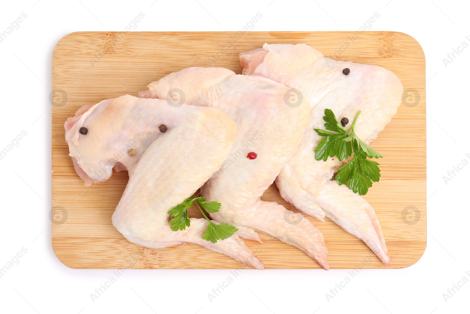 Photo of Raw chicken wings with spices and parsley on white background, top view