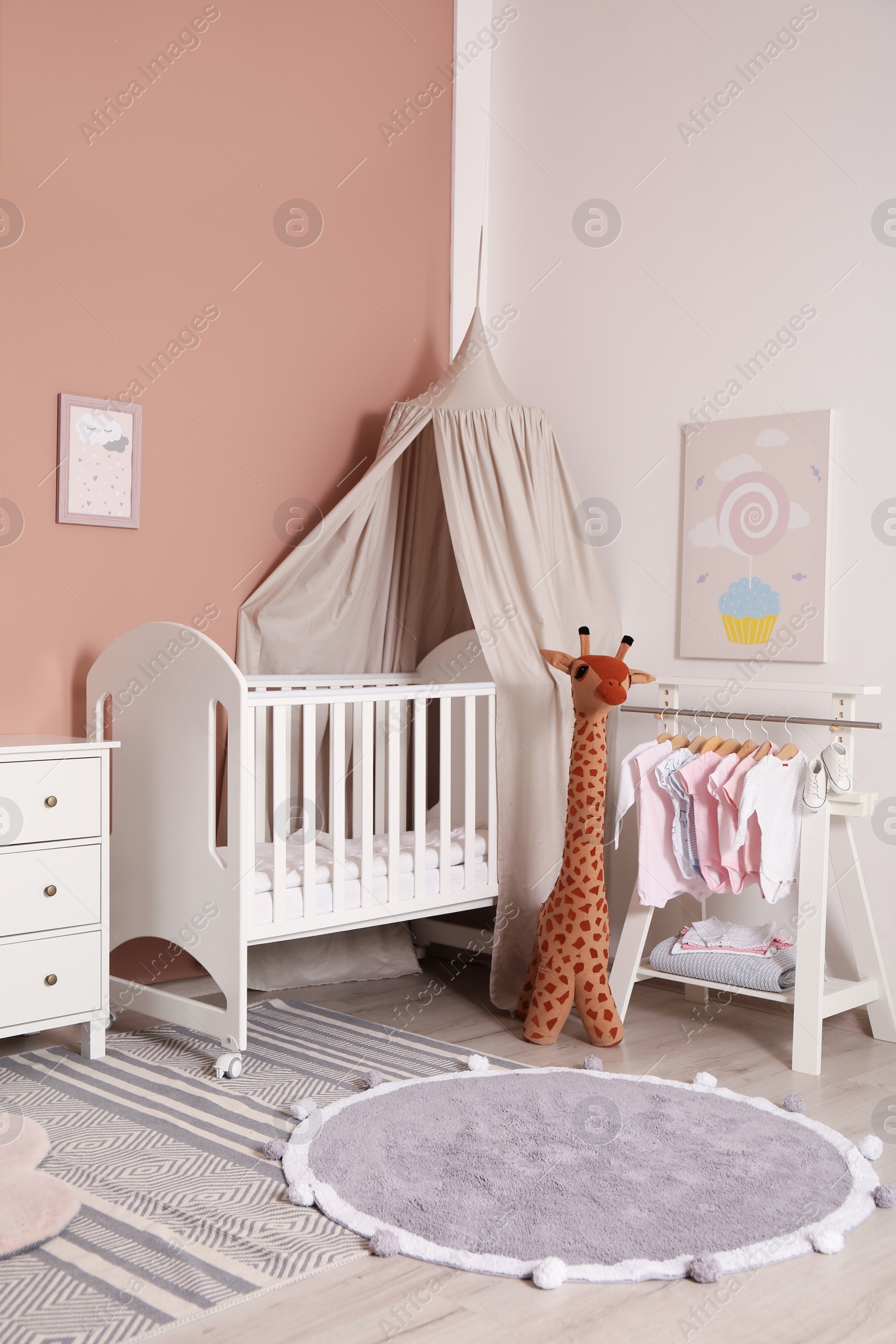 Photo of Baby room interior with stylish furniture and comfortable crib