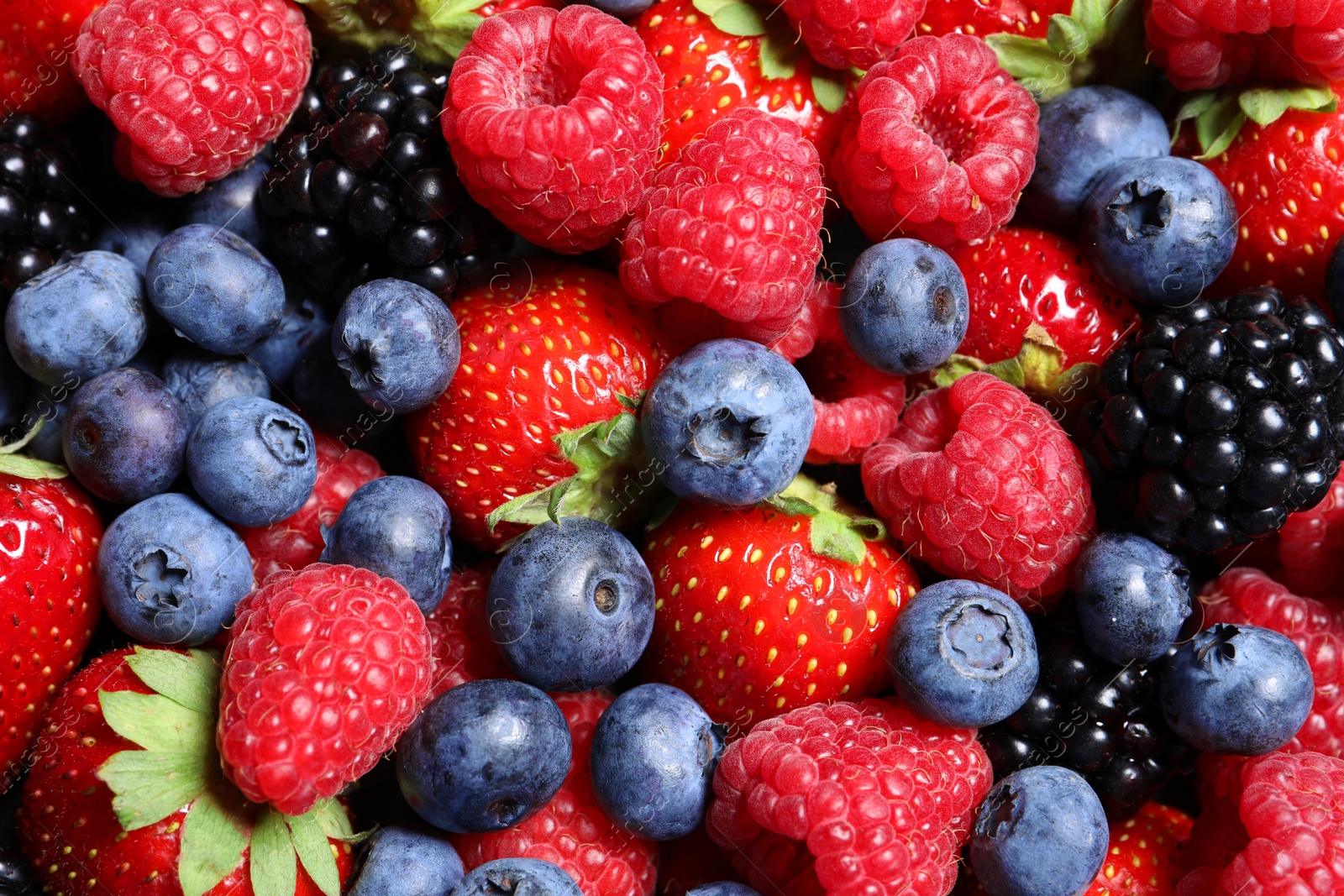 Photo of Assortment of fresh ripe berries as background, top view