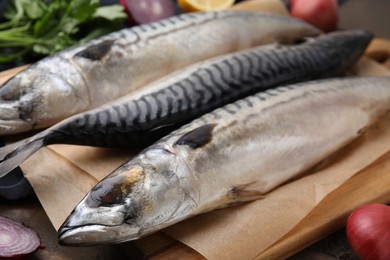 Photo of Tasty salted mackerels on table, closeup view