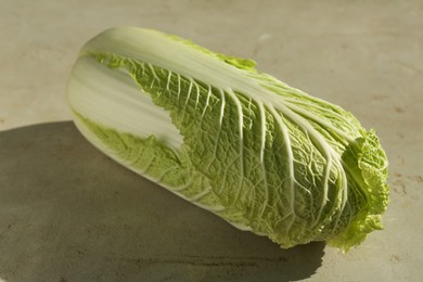 Photo of Fresh ripe Chinese cabbage on gray textured table, closeup