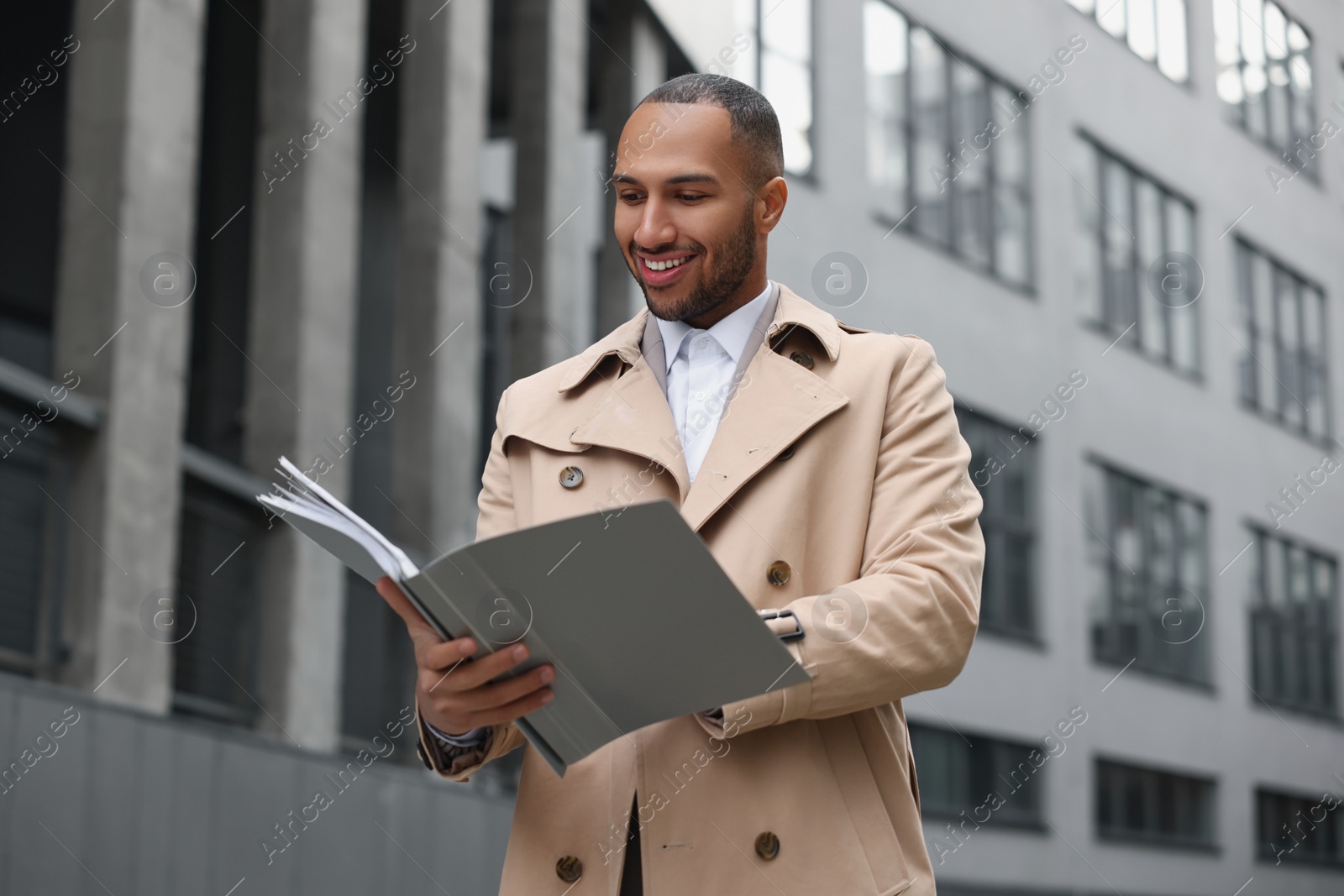 Photo of Happy man with folders outdoors. Lawyer, businessman, accountant or manager