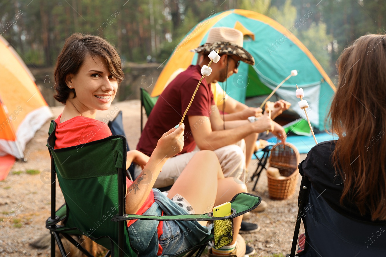 Photo of People having lunch near camping tent outdoors