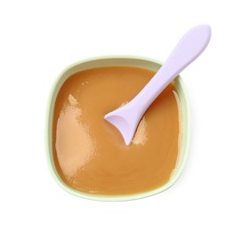 Photo of Tasty baby food and spoon in bowl isolated on white, top view