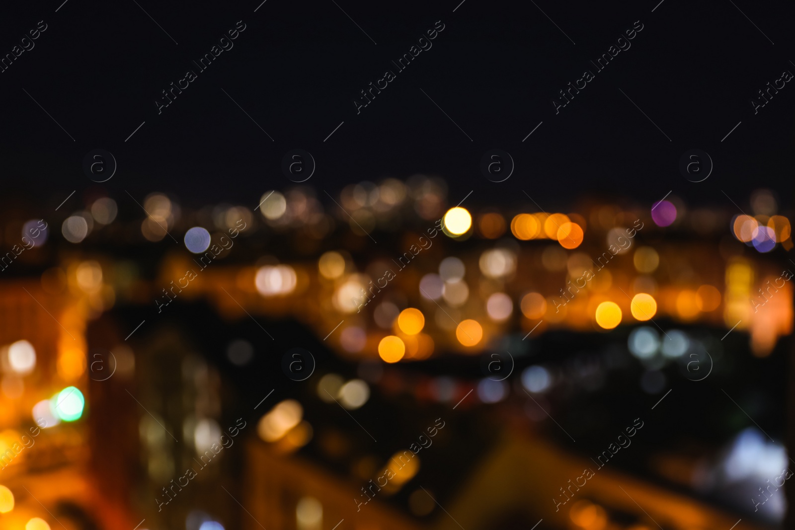 Photo of Blurred view of modern city at night. Bokeh effect