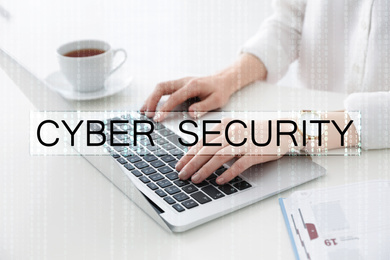 Cyber security concept. Woman working with laptop at table indoors, closeup