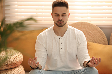 Photo of Young man during self-healing session in therapy room