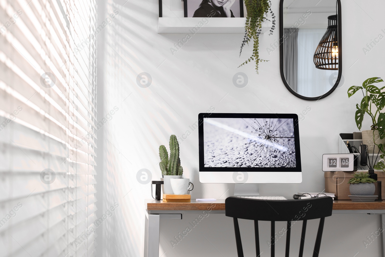 Photo of Cozy workspace with computer on wooden desk at home