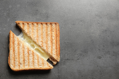 Image of Tasty toast sandwiches with cheese on grey table, top view. Space for text