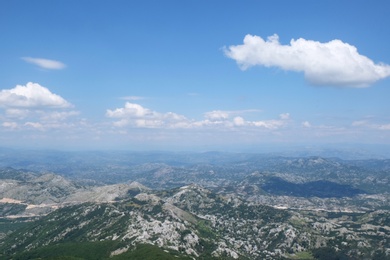 Image of Picturesque view of beautiful mountains under blue sky with clouds