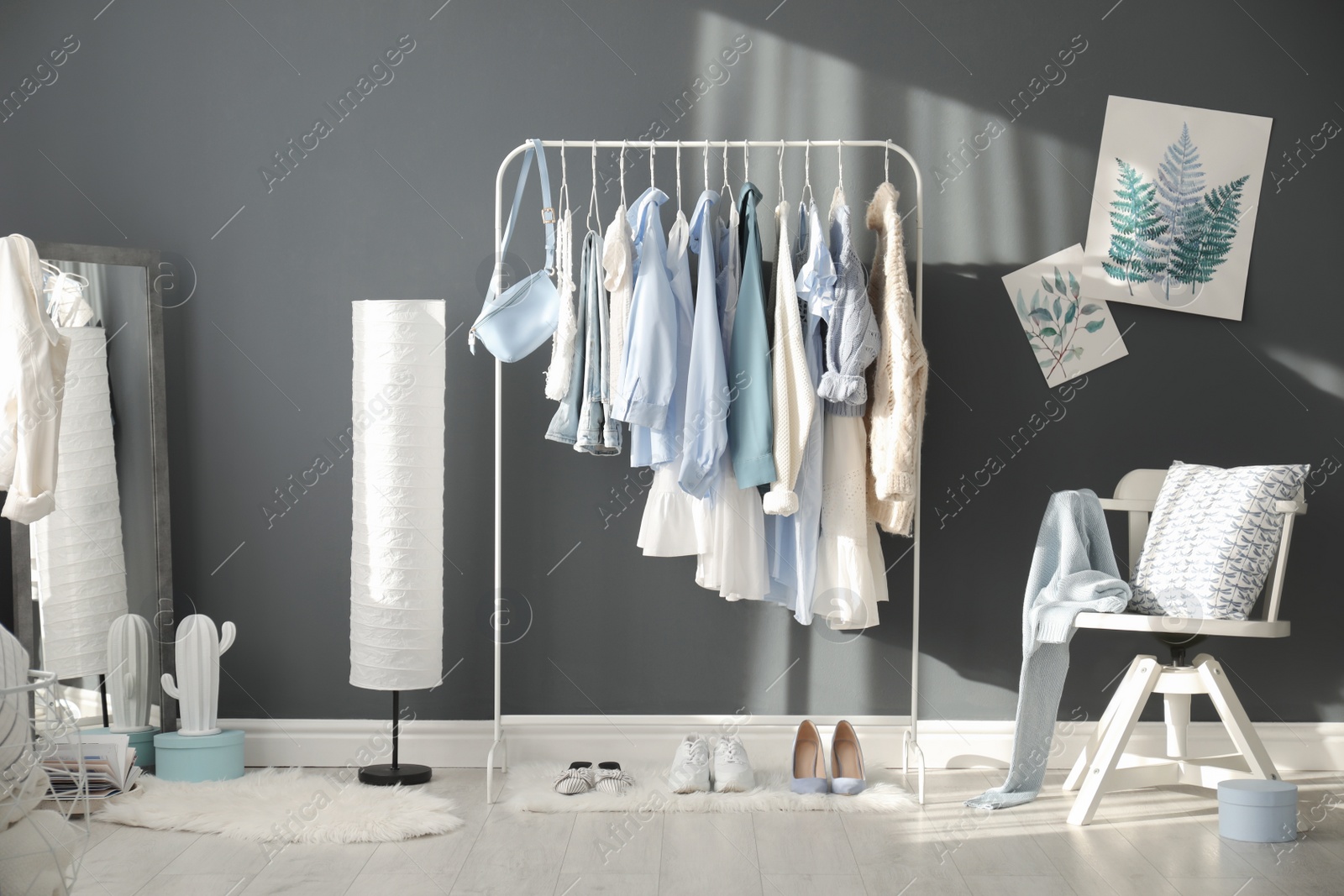 Photo of Dressing room interior with clothing rack and mirror