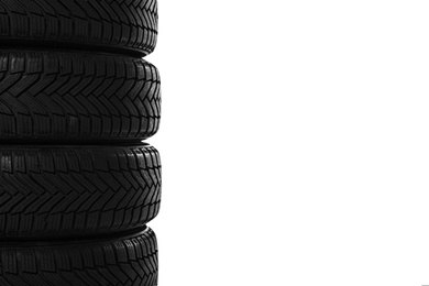 Photo of Set of new winter tires on white background