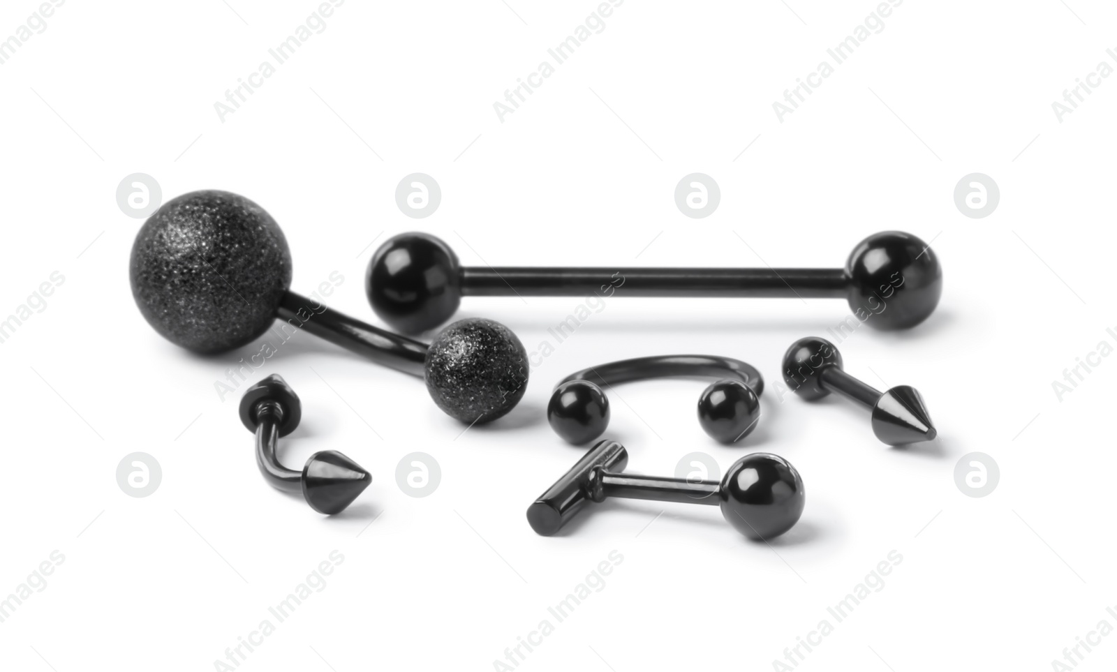 Photo of Stylish black piercing jewelry on white background