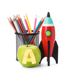 Image of Apple with carved letter A as school grade. Bright toy rocket and pencils on white background