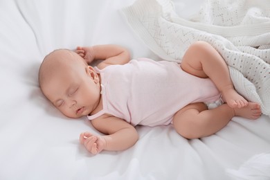 Cute little baby sleeping on bed, above view