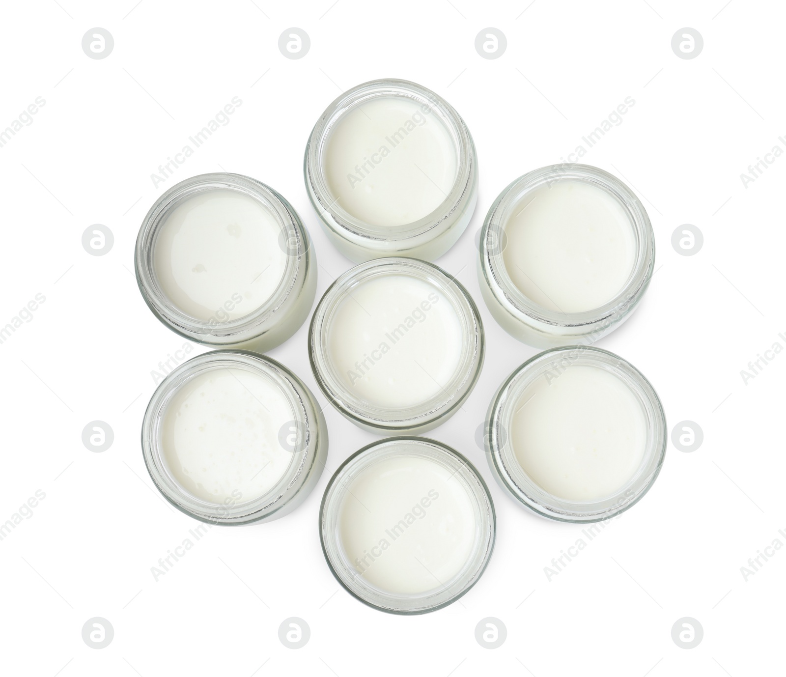 Photo of Glass jars with delicious homemade yogurt on white background, top view