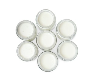 Photo of Glass jars with delicious homemade yogurt on white background, top view