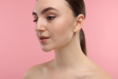 Photo of Portrait of beautiful woman on pink background