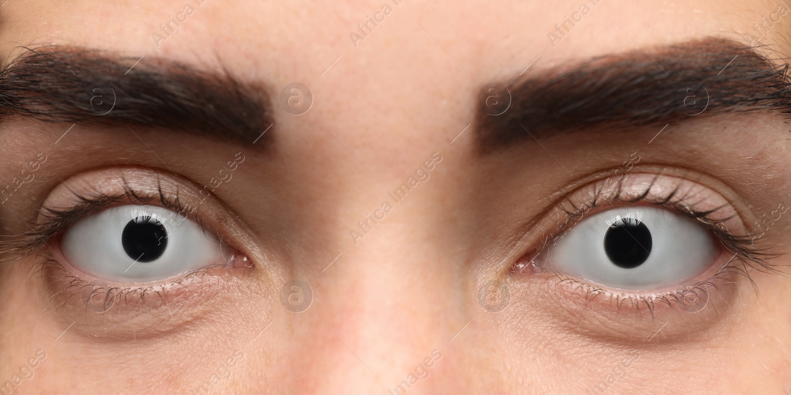 Photo of Mysterious witch with spooky eyes, closeup. Halloween party