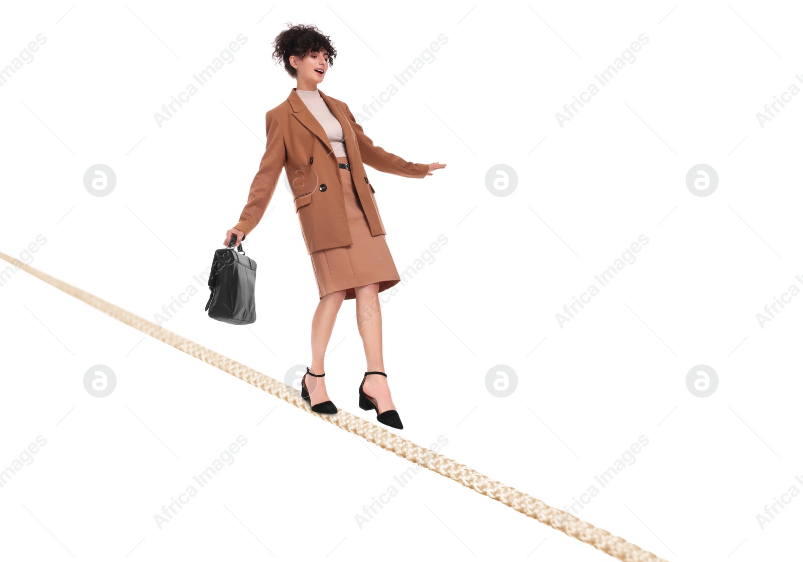 Image of Businesswoman walking rope against white background. Risk or balance concept