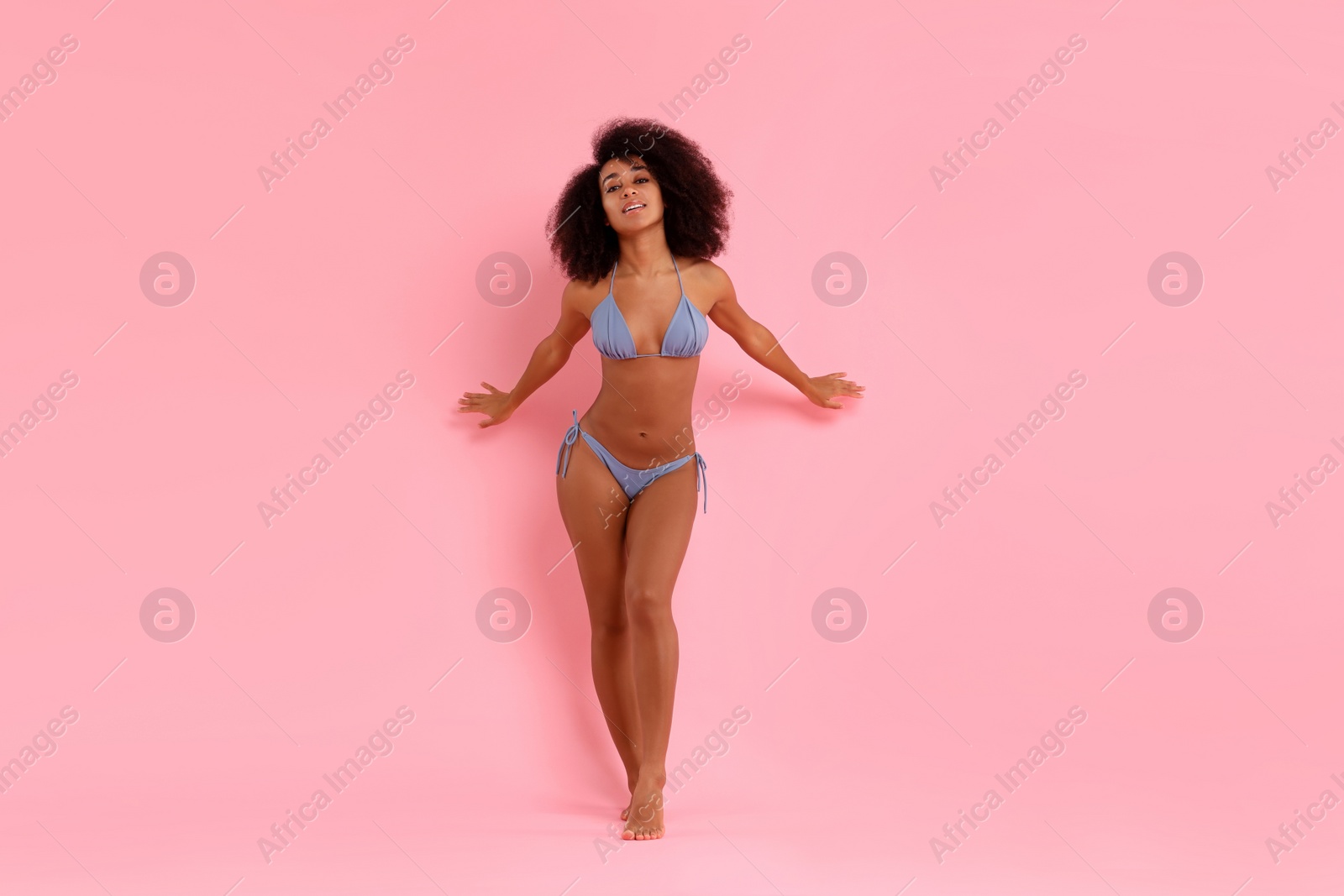 Photo of Beautiful woman in stylish bikini posing on pink background