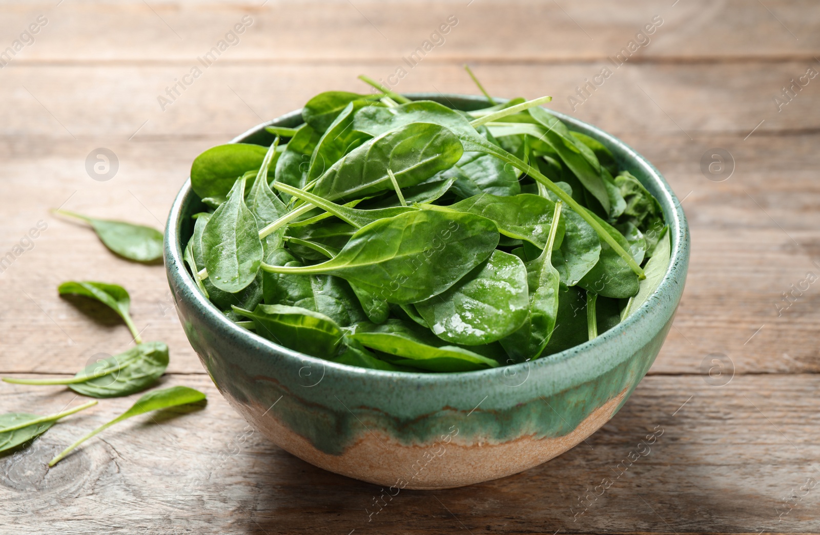 Photo of Fresh green healthy spinach on wooden table