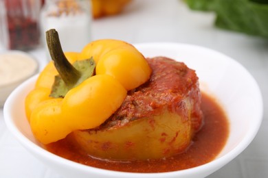 Photo of Delicious stuffed bell pepper on white tiled table, closeup