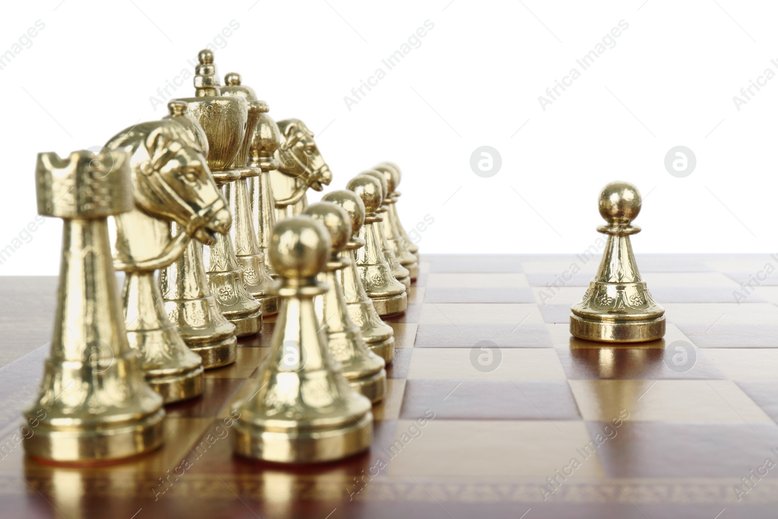 Photo of Pawn in front of other chess pieces on wooden board against white background