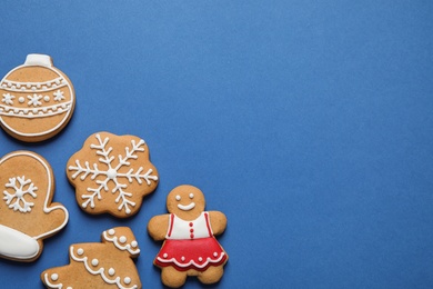 Photo of Flat lay composition with tasty homemade Christmas cookies on blue background, space for text