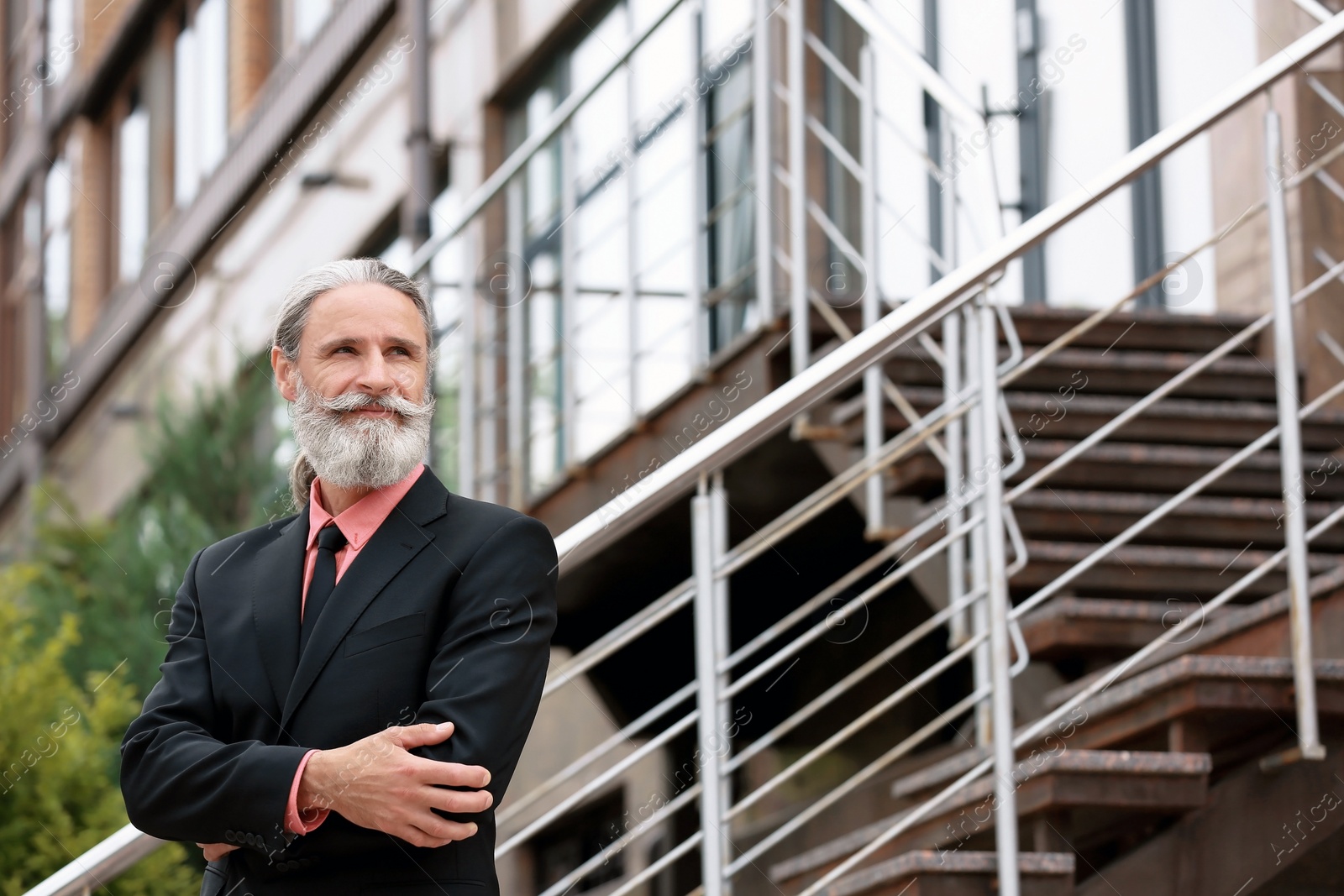 Photo of Handsome bearded mature man in suit, outdoors