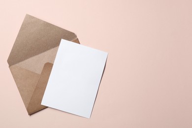 Letter envelope and card on beige background, top view. Space for text