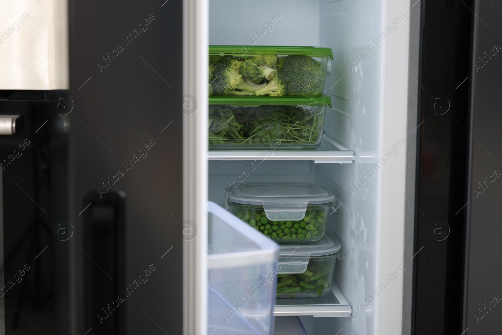 Photo of Glass containers with different fresh products in fridge. Food storage