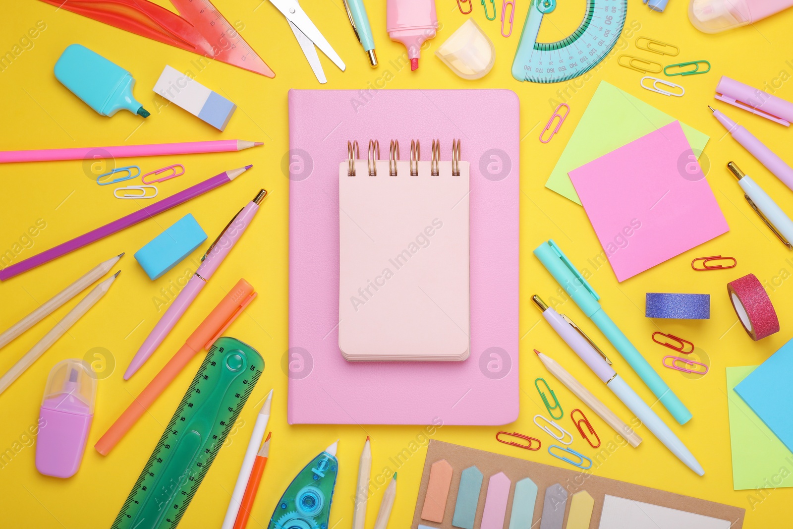 Photo of Flat lay composition with notebooks and other school stationery on yellow background, space for text. Back to school