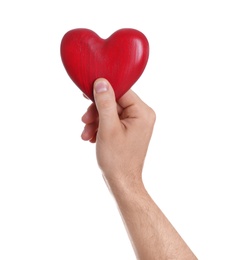 Man holding decorative heart in hand on white background, closeup