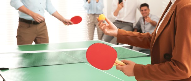 Image of Business people playing ping pong in office, closeup. Banner design