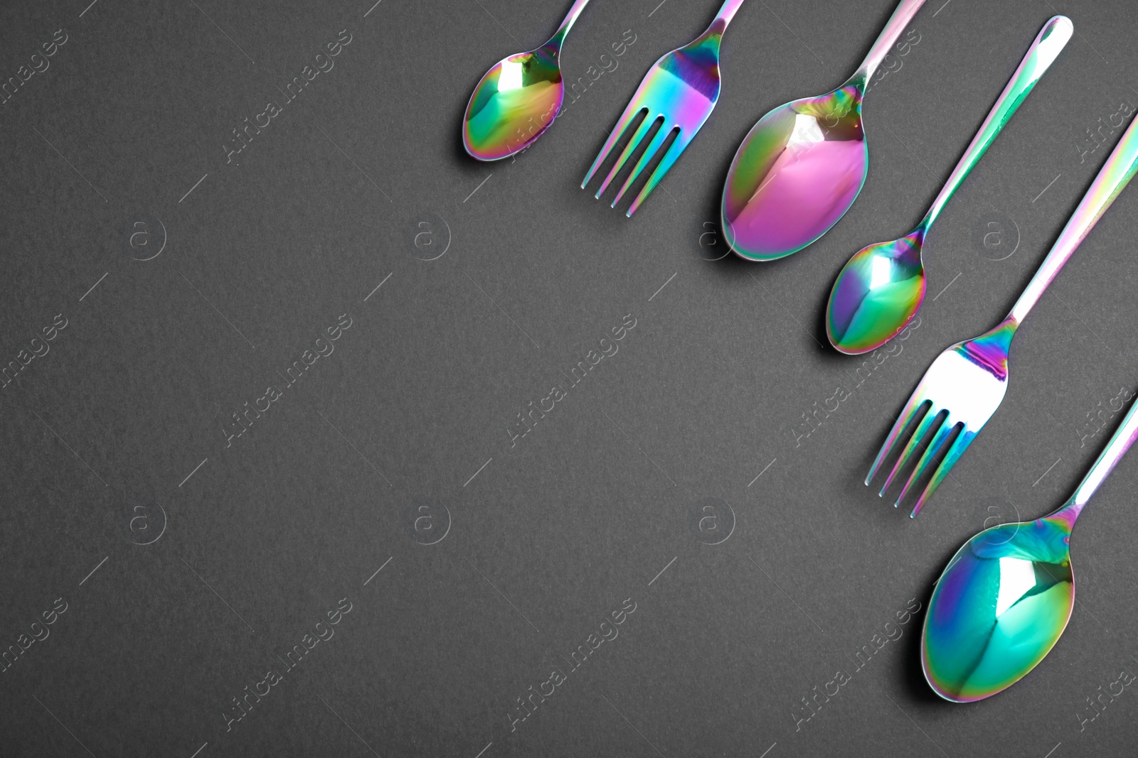 Photo of Set of new luxury cutlery on black background, flat lay with space for text