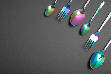 Set of new luxury cutlery on black background, flat lay with space for text