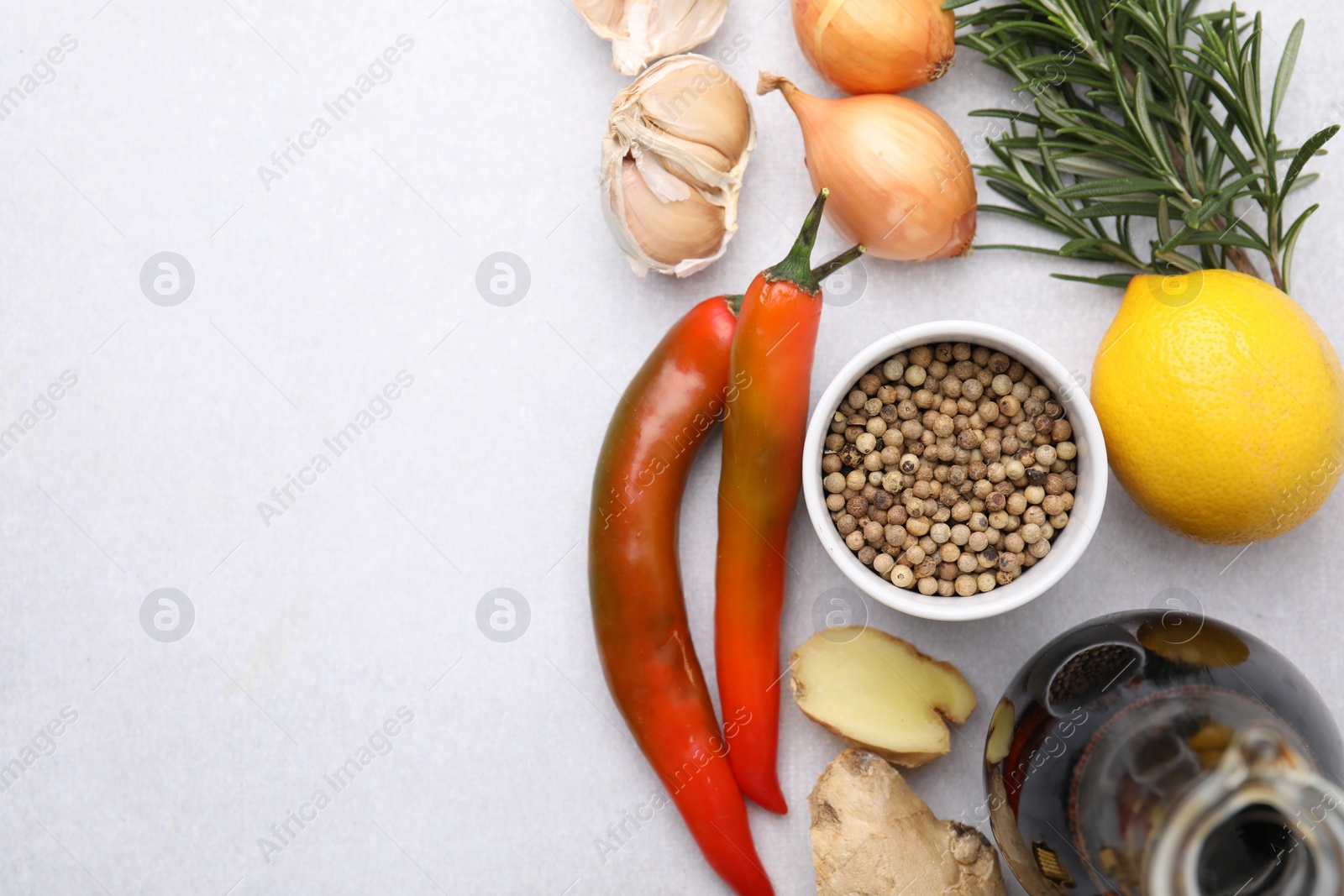 Photo of Flat lay composition with different fresh ingredients for marinade on light table, space for text