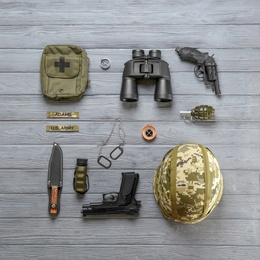 Set of military equipment on wooden background, flat lay