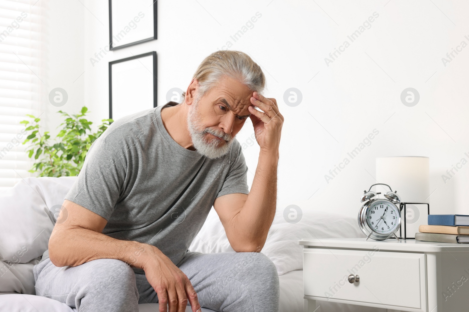 Photo of Sleepy senior man in bed at home